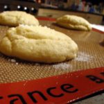 Close up of old-fashioned sugar cookies on a baking mat | Foodal