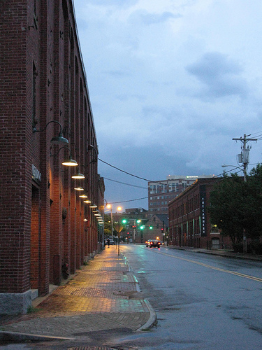 An image of a downtown road flanked by buildings on both sides.