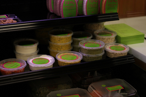 A counter filled with various packaged goods in plastic containers.