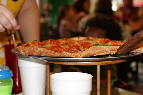 A photo showing a delicious looking pizza being served. 