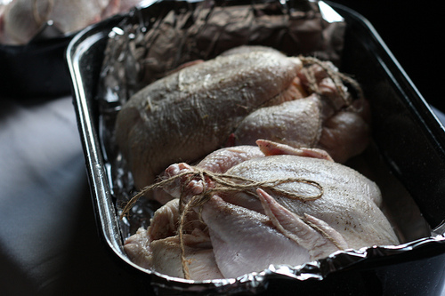 An image of two prepped chicken ready for roasting. 