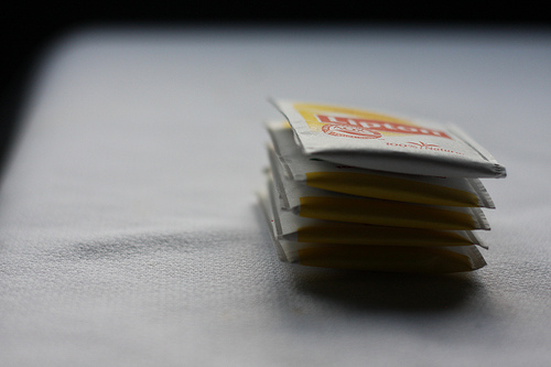 An image of a stack of tea packets on a table. 