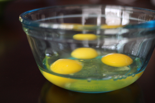An image of clear glass bowl with three eggs in it. 