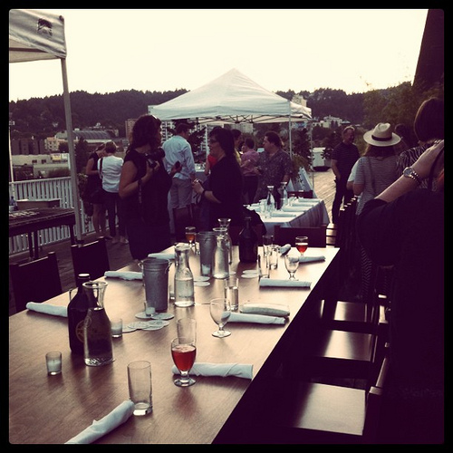 An image of people around a table during a late afternoon. 