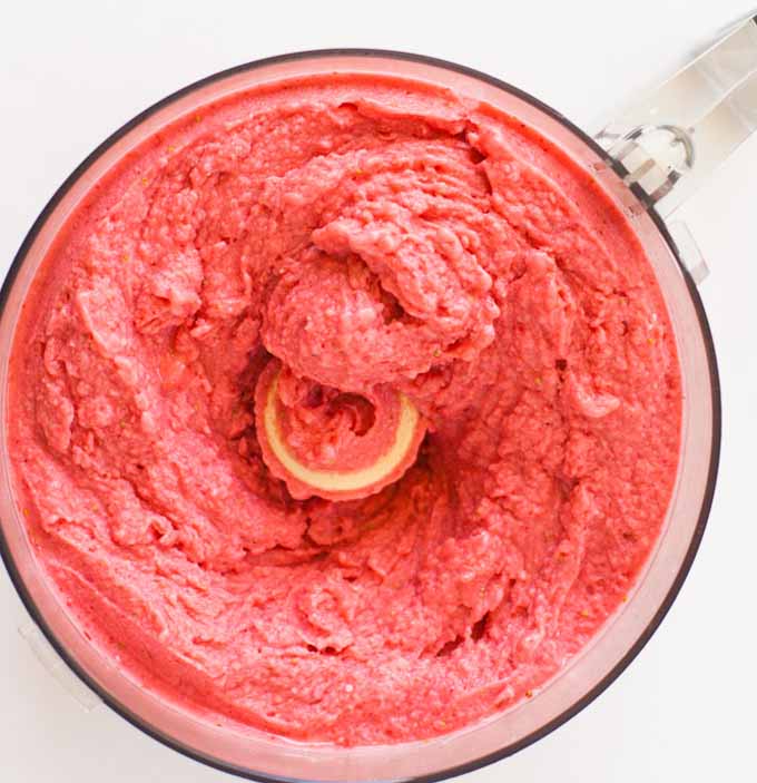 Top view of a strawberry and goat cheese sherbet blended in a food processor.