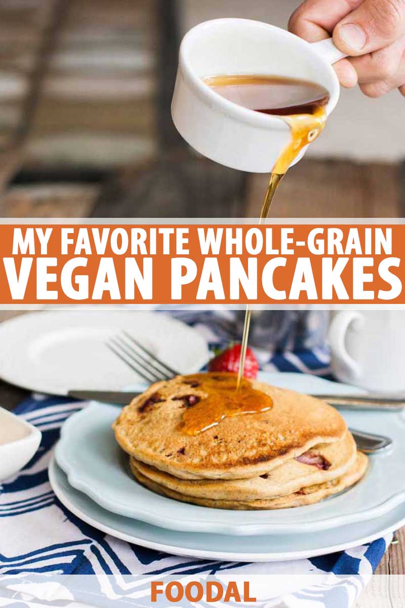 A human hand pours syrup over a stack of homemade vegan pancakes.