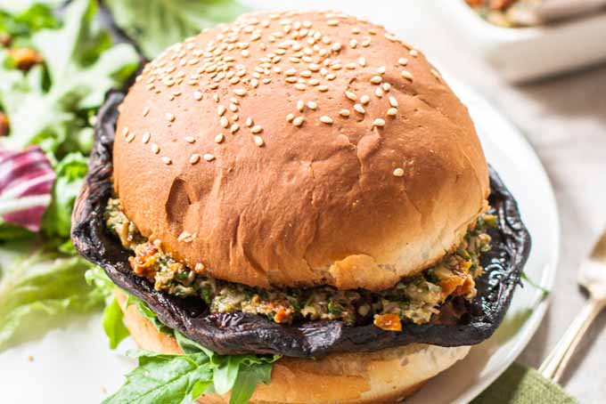 Oblique view of a vegan portabella mushroom burger on a bun.