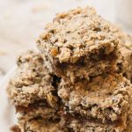 A close up of a stack of nutritious gluten-free and vegan breakfast bars that are made with whole ingredients and are similar to fig newtons.