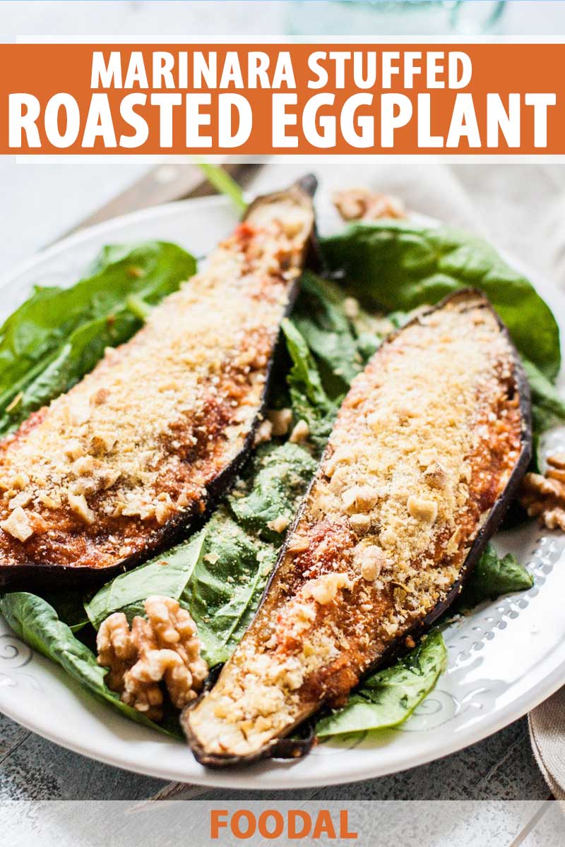 Stuffed vegan marinara and Parmesan eggplant on a white plate with spinach and walnuts, printed with white and orange text.