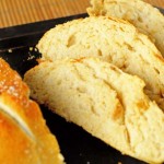 The best roasted garlic bread baked and complete on a cookie sheet - sliced with interior exposed