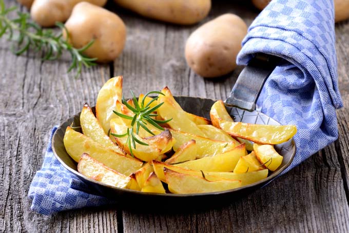 roasted potatoes with rosemary in french carbon steel frying pan