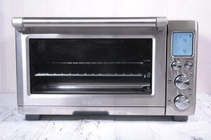Breville Smart Oven Air sitting on a white painted wooden surface
