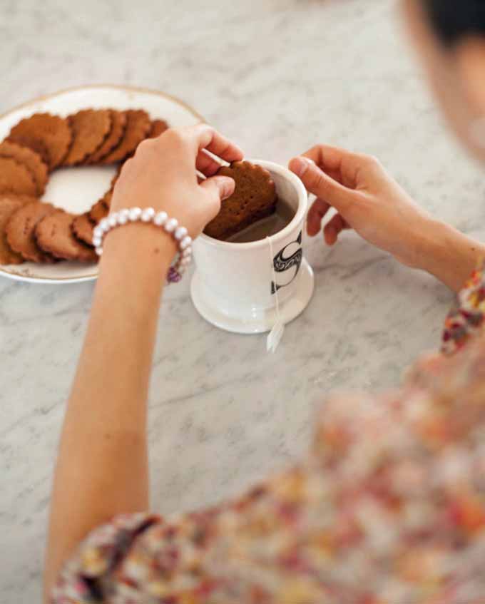 The author dunking Einkorn Spelt Homemade graham crackers in a mug of tea