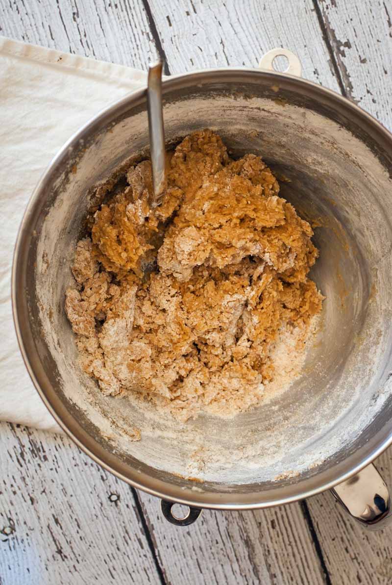 The ingredients blended withing a stainless mixing bowl full of vegan peanut butter cookie dough