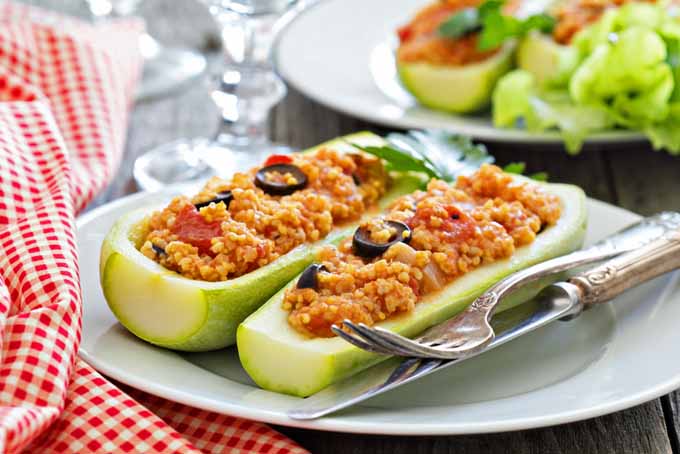 Vegan stuffed zucchini made with millet, tomatoes, and olives | Foodal.com
