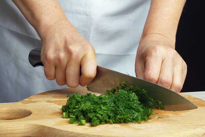 Chopping dill with a chef's knife | Foodal.com