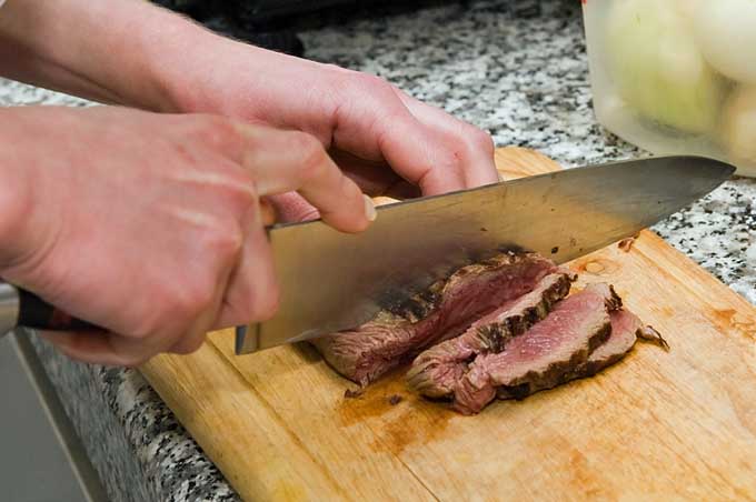Slicing meat with a chef's knife | Foodal.com