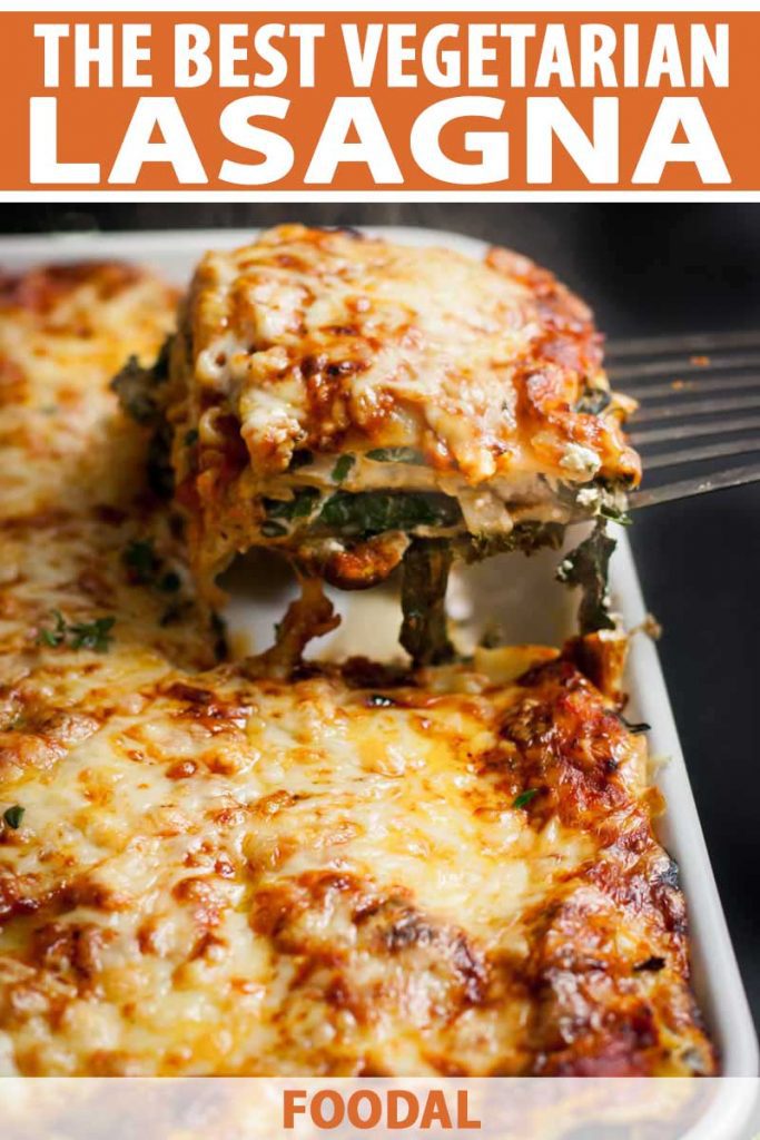 A spatula removes a portion of cheesy vegetarian lasagna from a casserole dish.