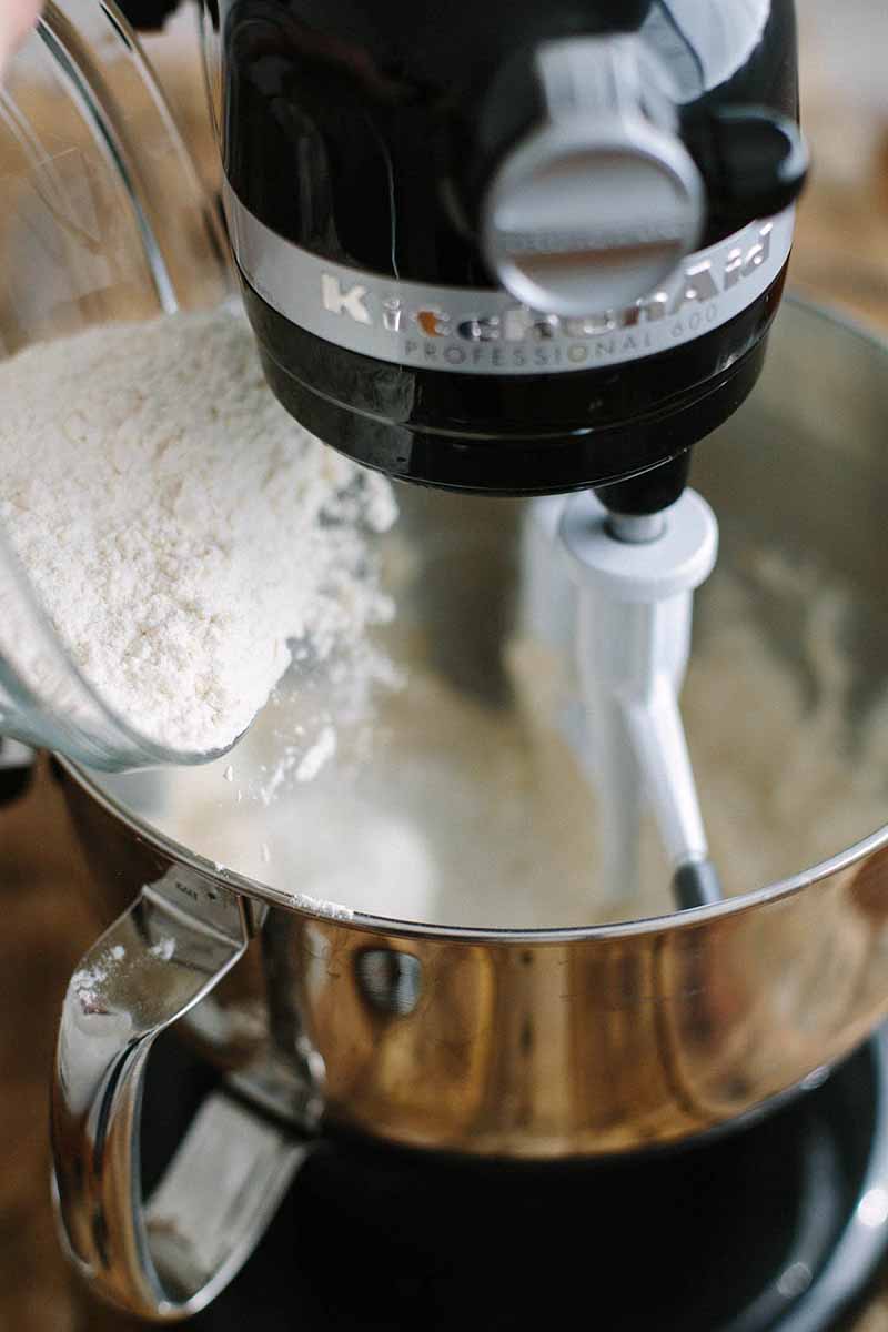 A stand mixer being used to blend the ingredients of the vegan lemon pound cake.