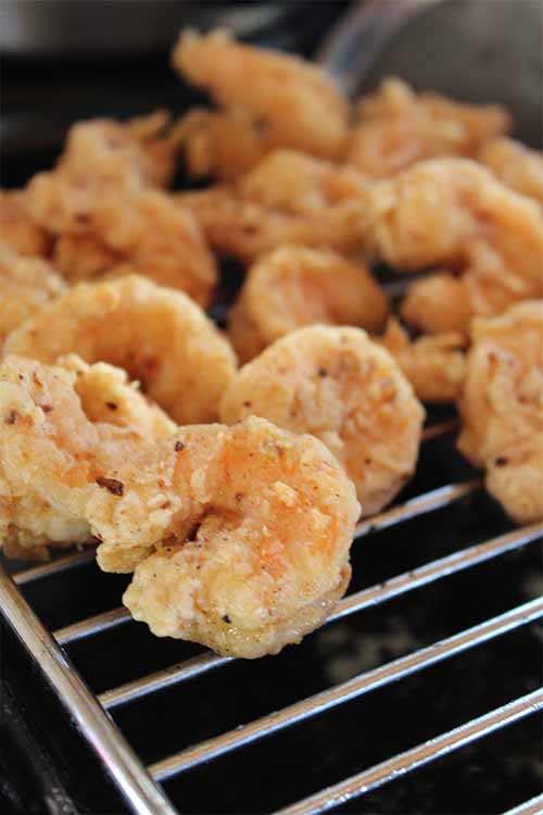 Want to make this tasty, crisp, flavorful fried shrimp to top hot dogs at your next barbecue? Get the recipe on Foodal: https://foodal.com/recipes/barbeque/surf-and-turf-po-boy-hot-dog/