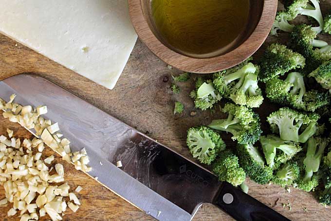 Prepare your ingredients by chopping up the the broccoli into florets and mincing the garlic | Foodal.com