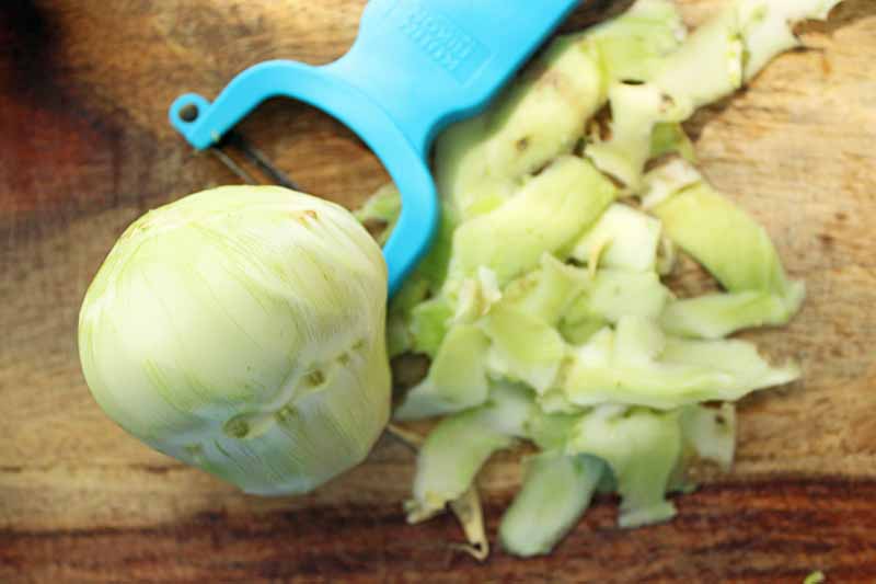 Top down view of a kohlrabi in the process of being peeled.