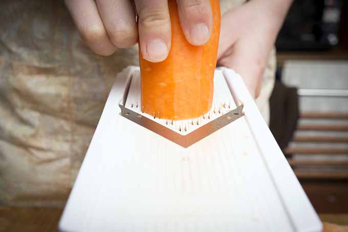A V slice mandoline cuts a carrot | Foodal.com