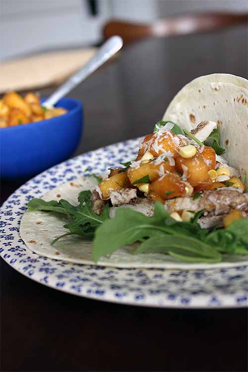 Spice things up on taco night with these marinated and grilled pork tacos, topped with homemade peach and corn salsa. We share the recipe: https://foodal.com/recipes/mexican-latin-america/pork-tacos-peach-corn-salsa/