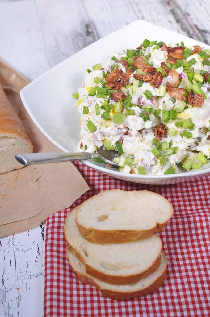 This loaded potato salad will rock your world! The tastes of sour cream, bacon, and feta cheese will make this THE most popular side dish at your next cookout or potluck! https://foodal.com/recipes/comfort-food/loaded-potato-salad/ ‎