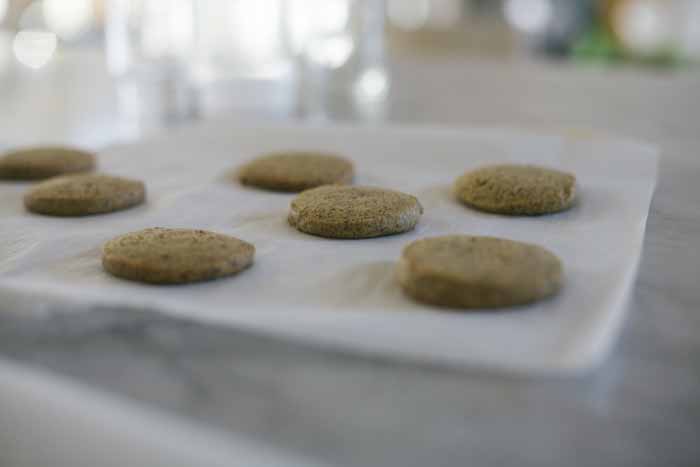 Oblique view of a batch of einkorn flour Earl Grey tea cookies on a baking tray. Selective focus with a diffused foreground and background.