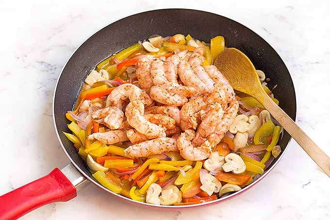 Spicy marinated shrimp bring a kick of flavor to homemade fajitas, with sauteed mushrooms, peppers, and onions.