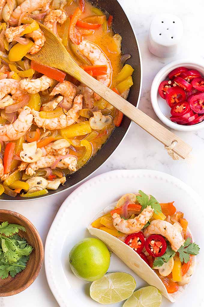 Make sizzling shrimp fajitas at home with spicy marinated shrimp and fresh vegetables. Get the recipe: https://foodal.com/recipes/fish-and-seafood/sizzling-shrimp-fajitas/