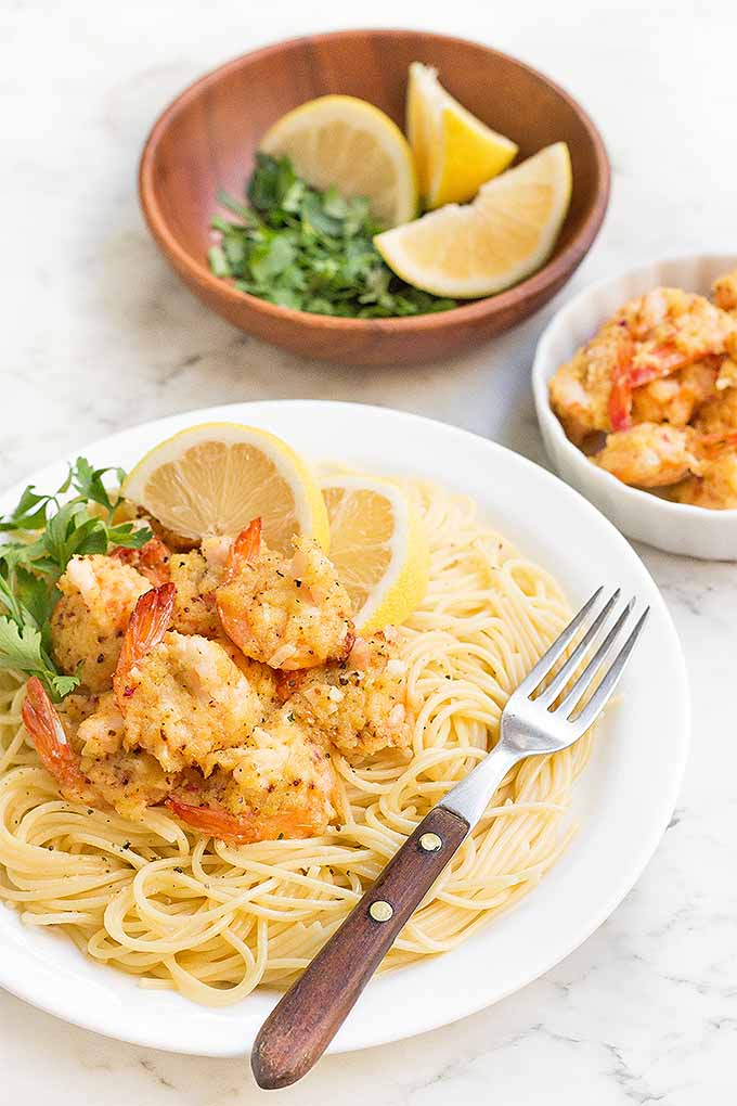 This baked version of a classic shrimp scampi is made with a rich, buttery breadcrumb mixture, flavored with shallots, garlic, and white wine. It's delicious served over pasta. Try the recipe for dinner tonight, or pin it for later: https://foodal.com/recipes/fish-and-seafood/classic-buttery-baked-shrimp-scampi/