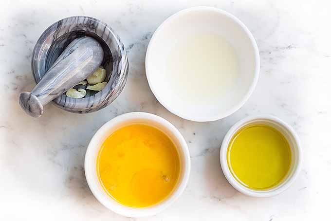 Whip up a batch of homemade lemon aioli with egg yolks, lemon juice, smashed garlic, and oil. | Foodal.com