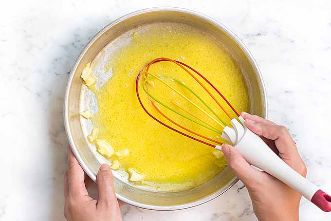 Combine fresh lemon juice, smashed garlic, salt, pepper, egg yolks and oil to make a homemade lemon aioli dressing. | Foodal.com