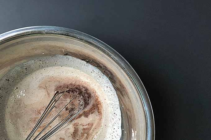 Whisking together hot heavy cream and chopped chocolate for ganache | Foodal.com