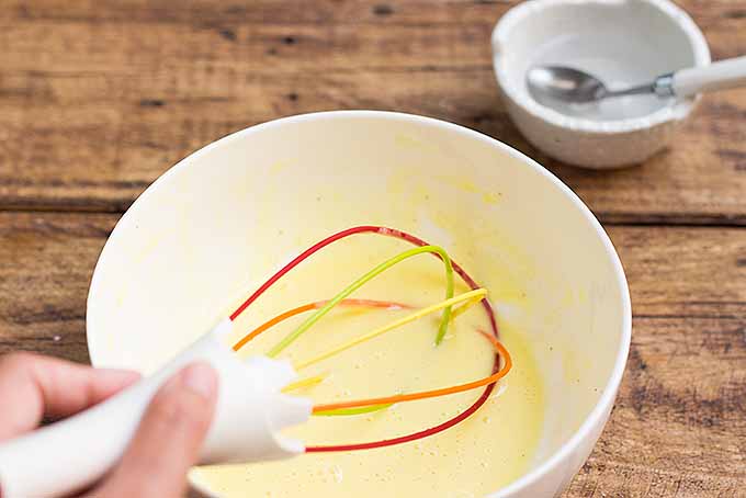 Whisking hot water into a broken mayo to make it creamy and perfect again | Foodal.com