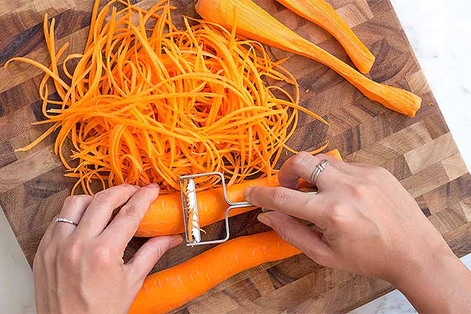Shred carrots into noodles with a julienne peeler to make this fresh springtime salad. | Foodal.com