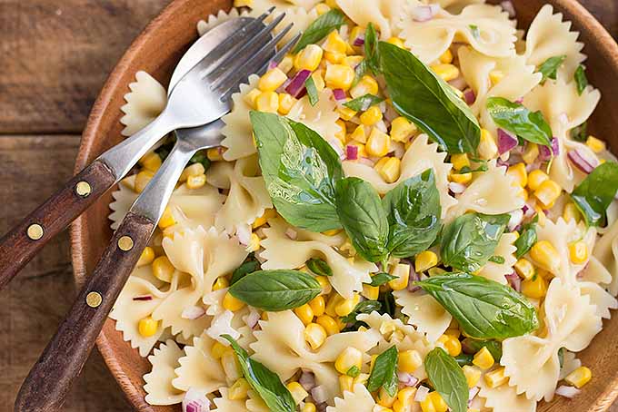 A bowl filled with the summer flavors of a fresh corn pasta salad. | Foodal.com