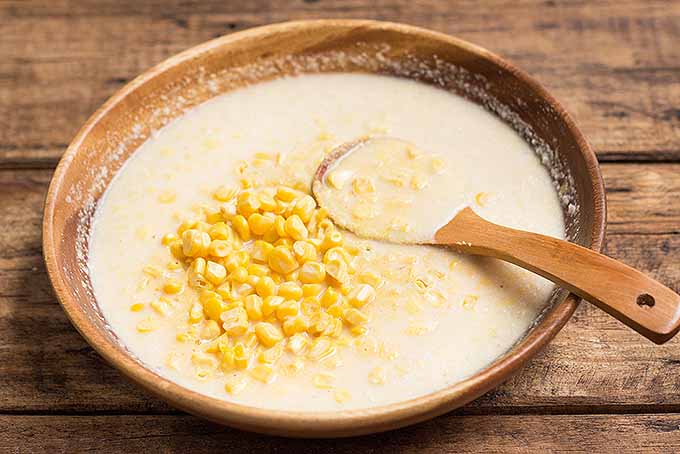Mixing in fresh corn kernels to the batter for sweet cornmeal pancakes. | Foodal.com