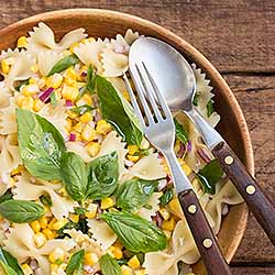 Pasta salad with corn, onions, basil and lemon. | Foodal.com