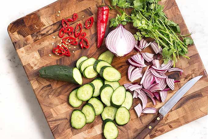 Getting all the veggies prepped for a cool and refreshing cucumber salad to serve alongside a spicy chicken satay. | Foodal.com