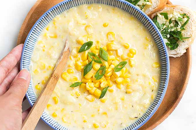 Just about to enjoy a big bowl of fresh corn chowder with garlic bread! | Foodal.com