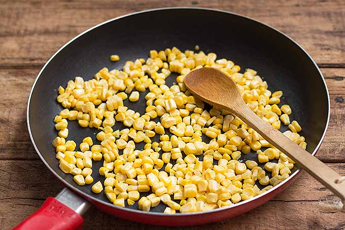 Cooking corn kernels for cornmeal pancakes. | Foodal.com