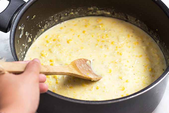 Mixing together the ingredients for the best summer corn chowder. | Foodal.com