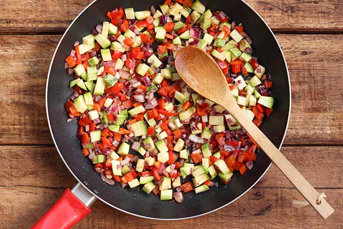 Cooking assorted veggies for a flavorful vegetarian burrito bowl. | Foodal.com