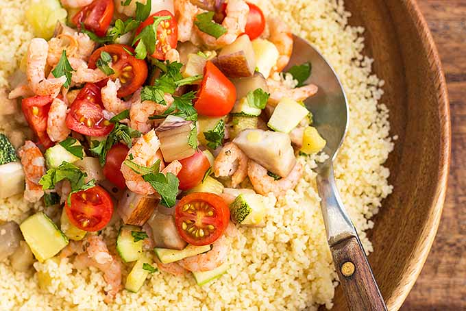 Enjoy a healthy bowl of couscous with shrimp and mixed vegetables. | Foodal.com