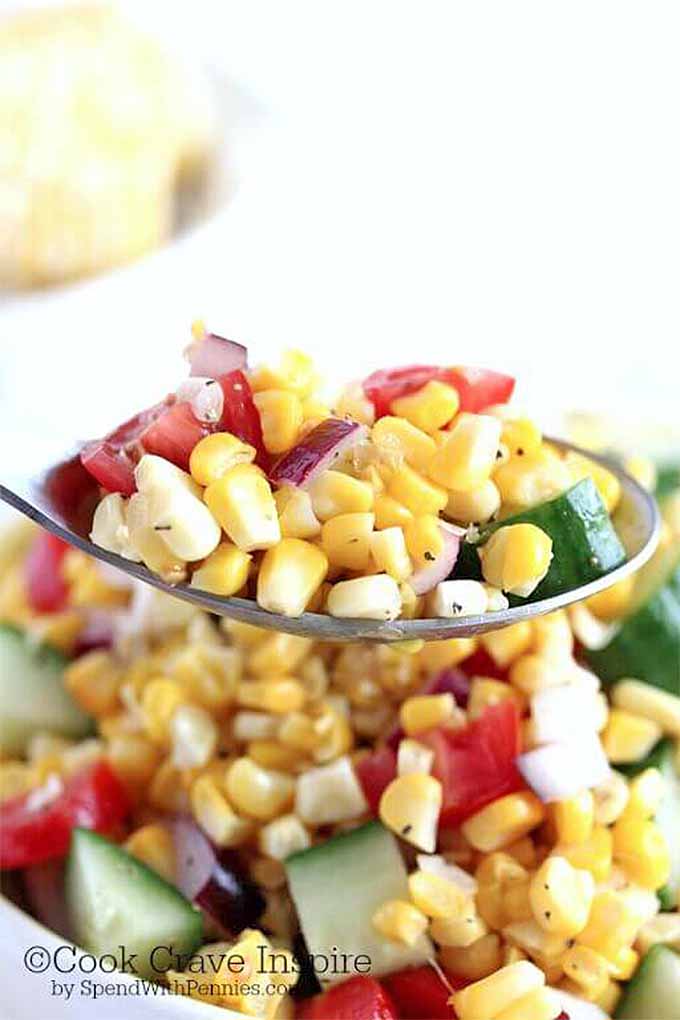 Serve up a delicious salad that features the summertime veggie garden's bounty: cucumber, tomato, and sweet corn. We share this recipe and more: https://foodal.com/knowledge/paleo/best-sweet-corn-recipes/