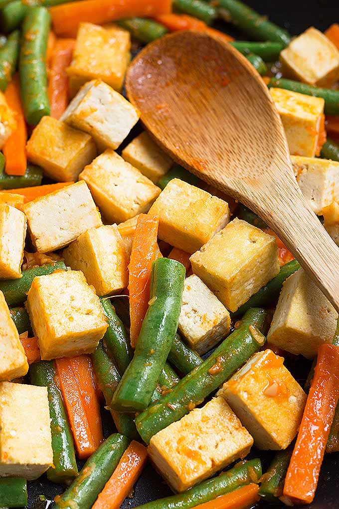 This simple tofu, green bean, and carrot stir-fry is filled with vegetables and flavored with ginger, garlic, and Sriracha sauce for extra kick! Get the recipe from Foodal today: https://foodal.com/recipes/vegetarian-vegan/sriracha-tofu-vegetable-stir-fry/ 