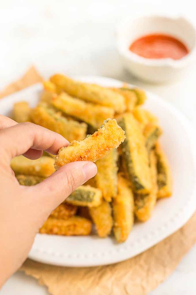 Deep-fried zucchini fries are out-of-this-world delicious, crispy, and so addictive! Get the recipe now on Foodal: https://foodal.com/recipes/appetizers/deep-fried-zucchini-fries/